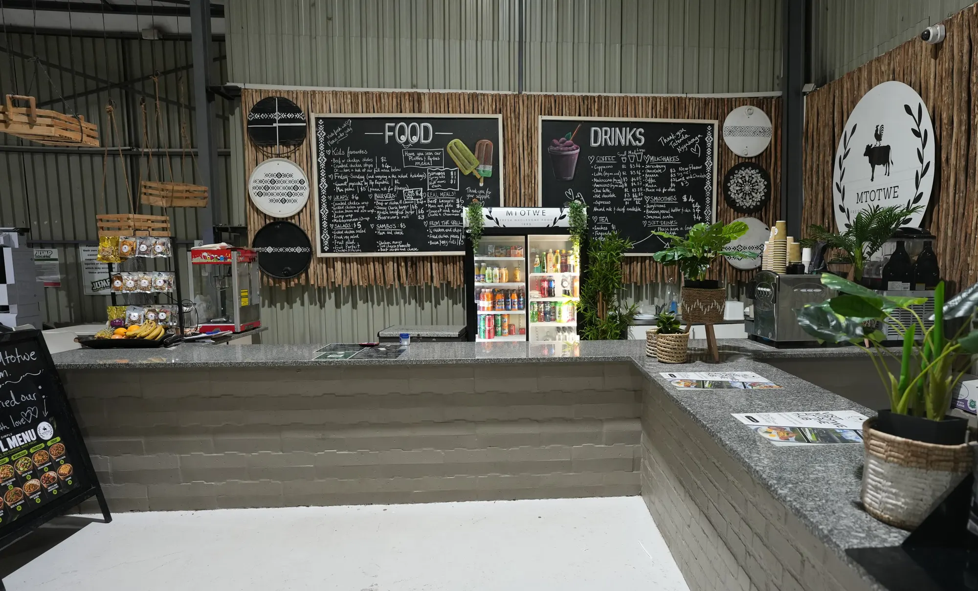 Café counter, menu boards and plants at Jump Trampoline Park, Harare