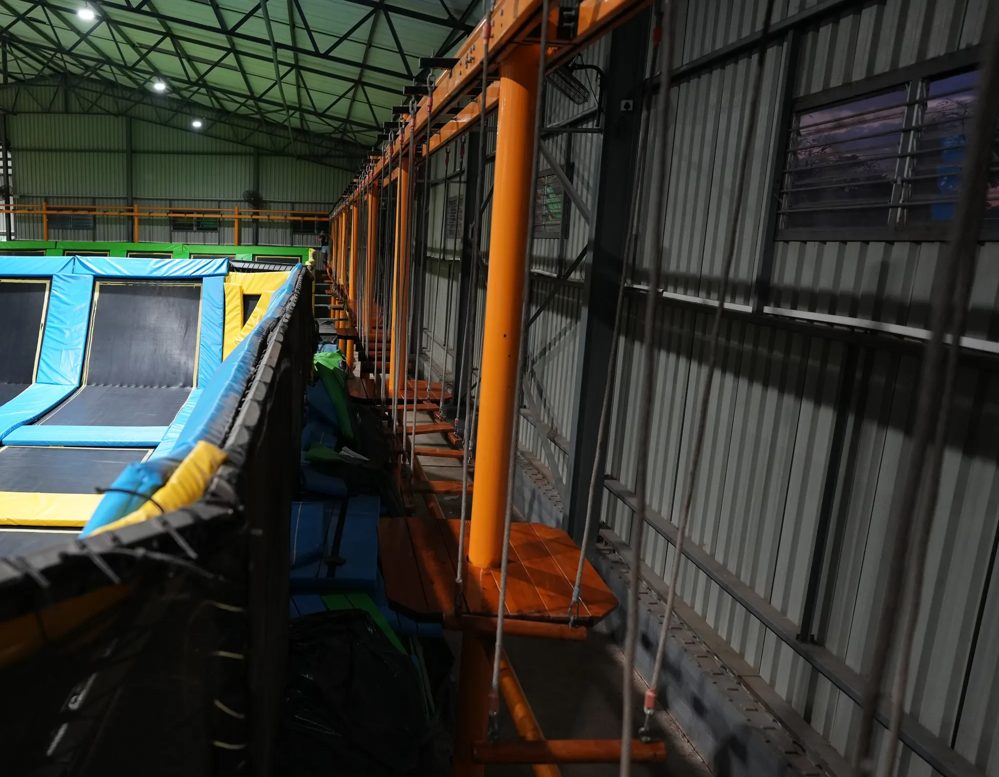 Harness track of the obstacle course running along the wall above the courts at Jump Trampoline Park, Harare
